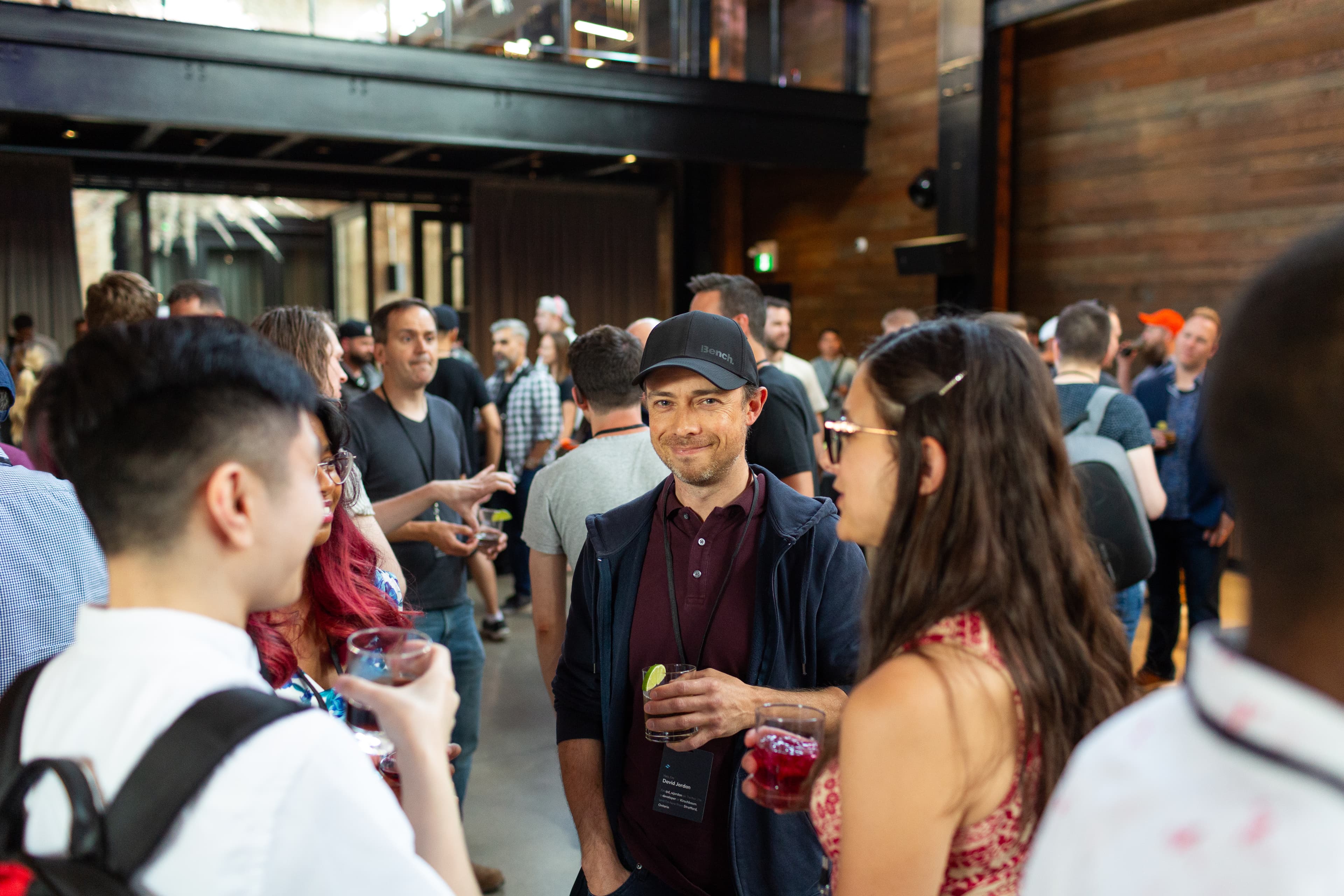 Attendees talking and enjoying drinks before the event